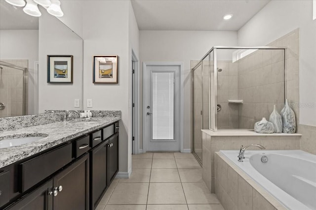 bathroom with vanity, tile patterned floors, and plus walk in shower