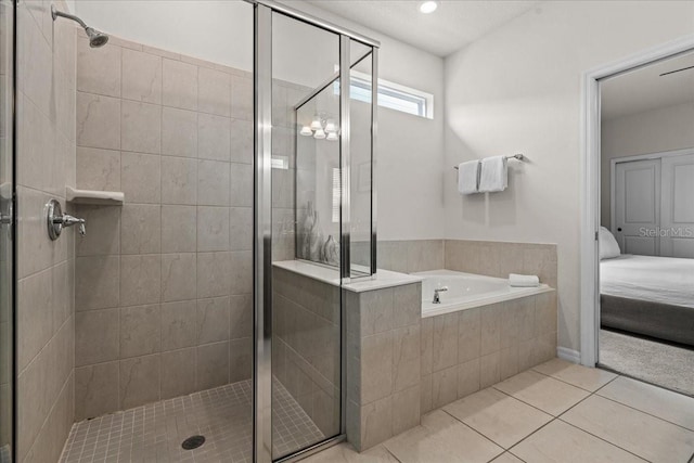 bathroom featuring shower with separate bathtub and tile patterned flooring