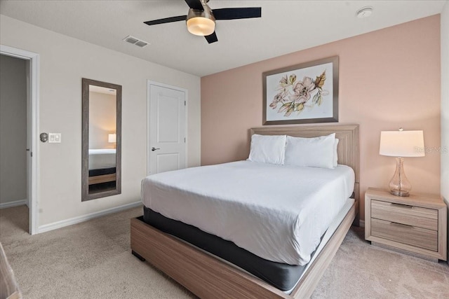 bedroom with ceiling fan and light carpet