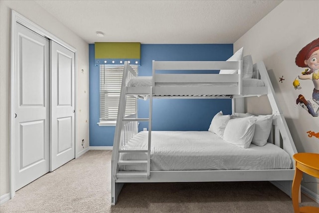 bedroom with carpet floors and a textured ceiling