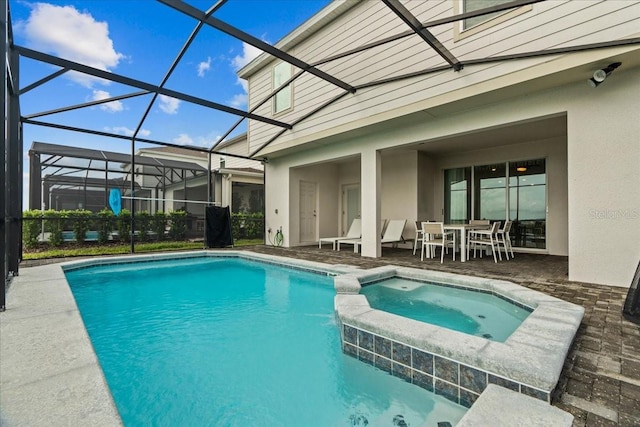 view of swimming pool with a lanai, a patio, and an in ground hot tub