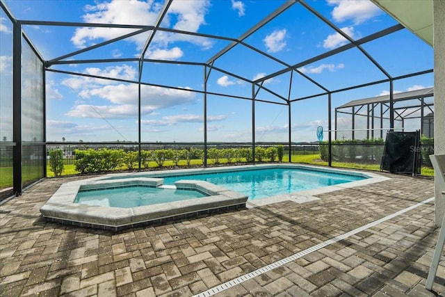 view of pool featuring an in ground hot tub, a lanai, and a patio area