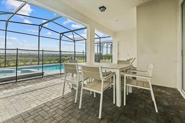 view of patio / terrace featuring a pool with hot tub and a lanai