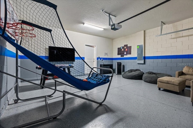 garage with a garage door opener and electric panel