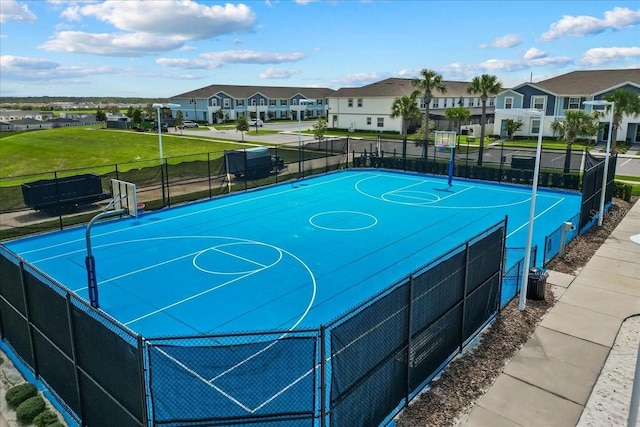 view of basketball court featuring a lawn