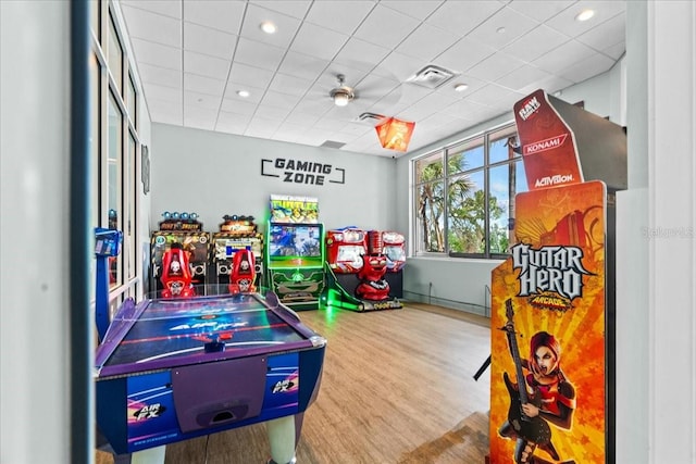 rec room with hardwood / wood-style flooring and a paneled ceiling