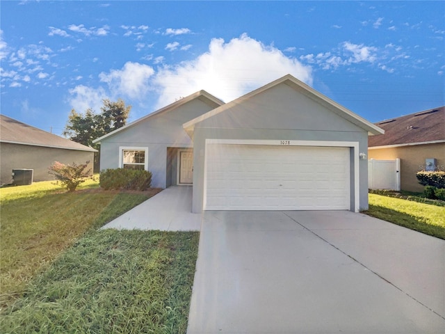 single story home featuring a garage and a front yard