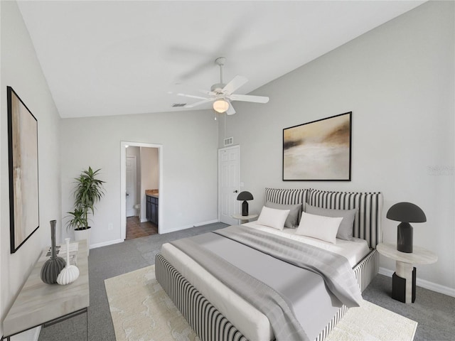 carpeted bedroom featuring lofted ceiling, ceiling fan, and ensuite bath