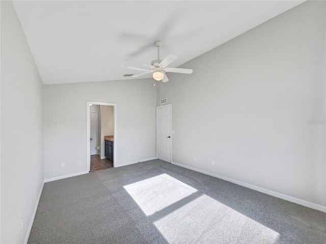 unfurnished bedroom with lofted ceiling, carpet flooring, ceiling fan, and ensuite bath