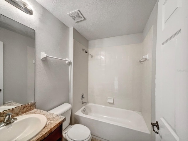 full bathroom with toilet, tiled shower / bath combo, a textured ceiling, and vanity