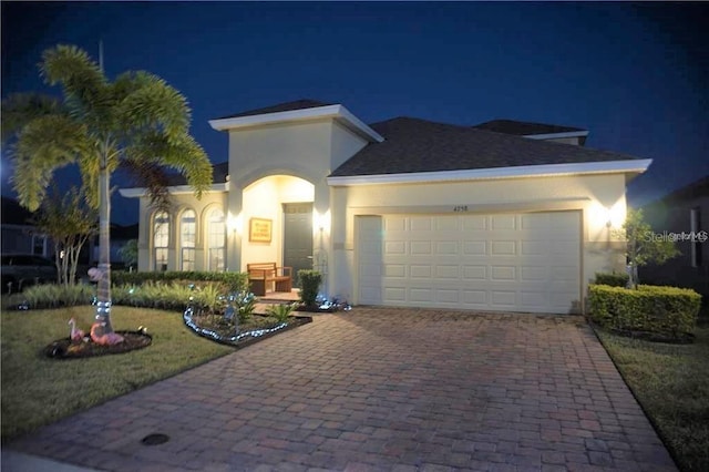 view of front facade with a garage and a lawn