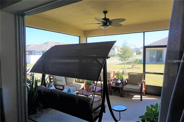 sunroom with a healthy amount of sunlight and ceiling fan