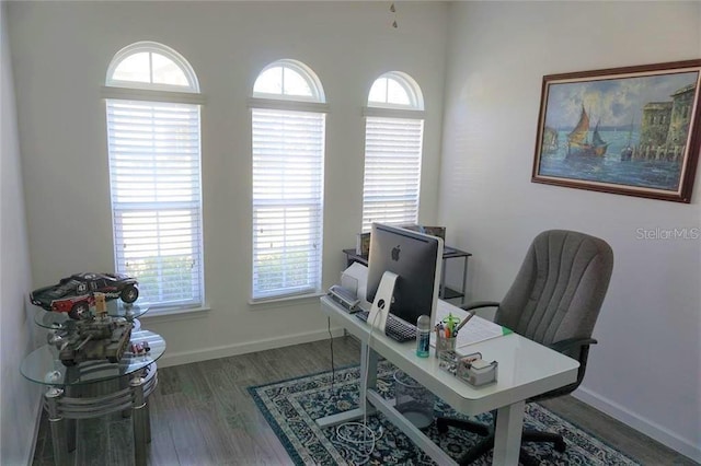 home office with dark hardwood / wood-style floors