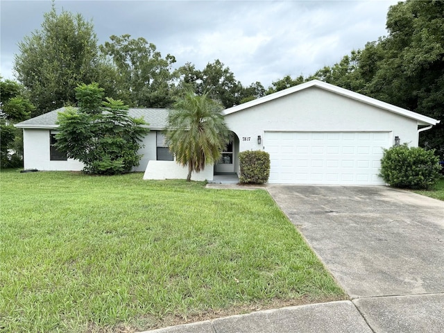 ranch-style house featuring a garage and a front yard