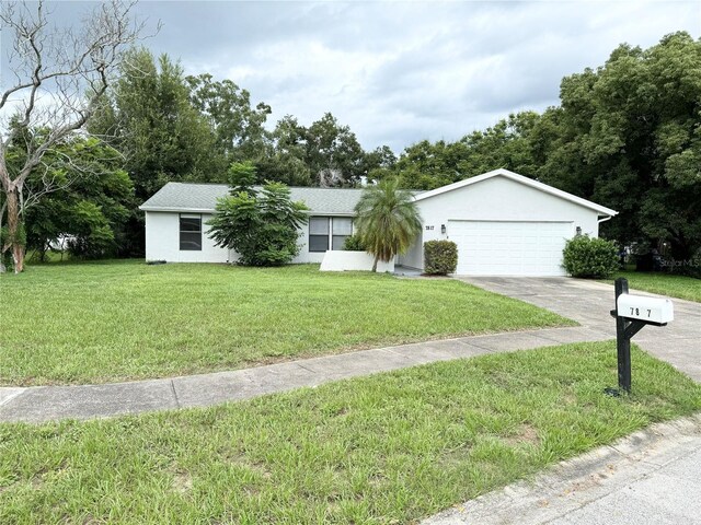 ranch-style house featuring a front yard and a garage