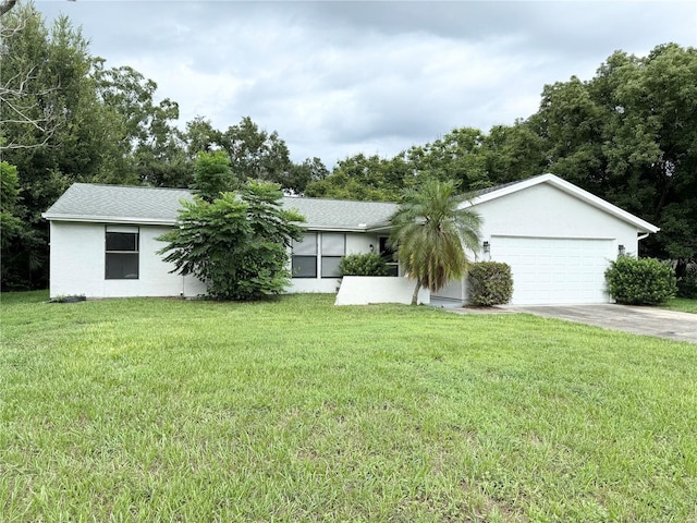 ranch-style house featuring stucco siding, an attached garage, driveway, and a front yard