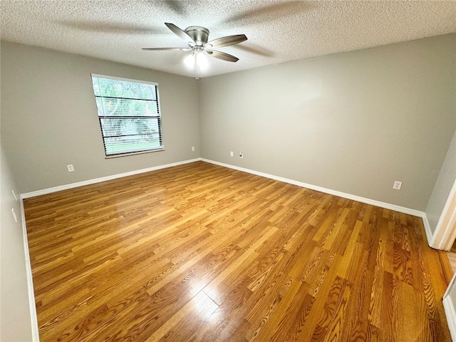 unfurnished room with a textured ceiling, ceiling fan, and light wood-type flooring