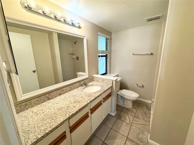 bathroom with visible vents, baseboards, toilet, a tile shower, and vanity