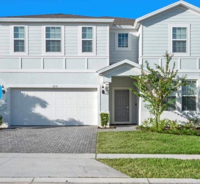 view of front of home featuring a front yard and a garage