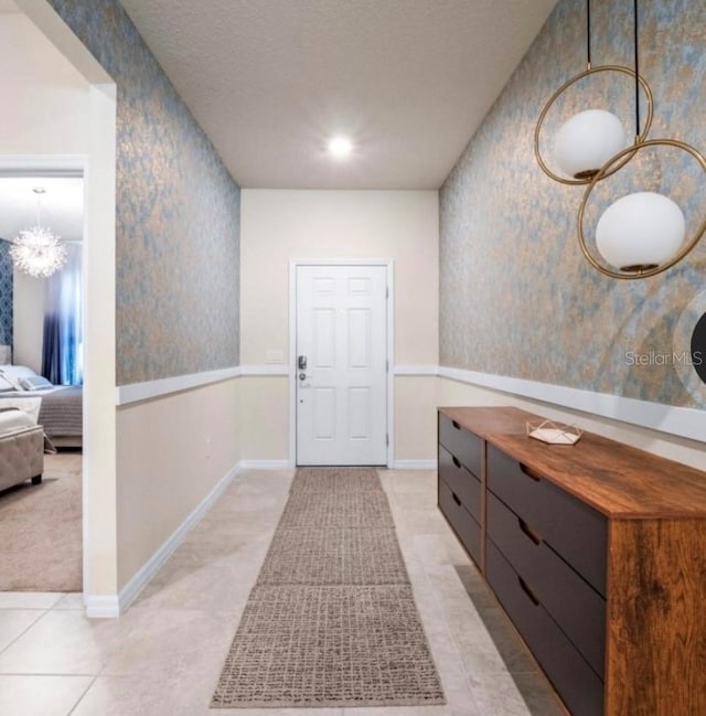 interior space with light tile patterned floors and a textured ceiling