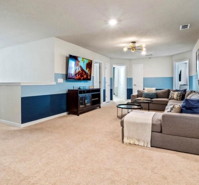 living room featuring an inviting chandelier, a textured ceiling, and carpet floors