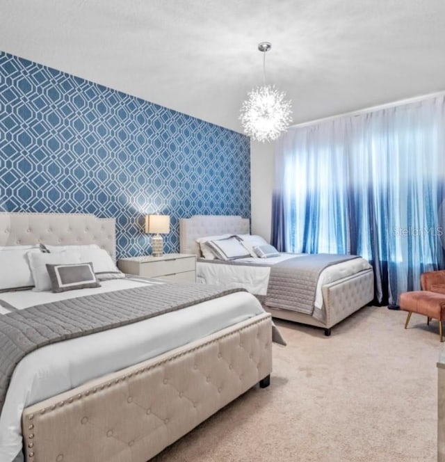 carpeted bedroom with a notable chandelier