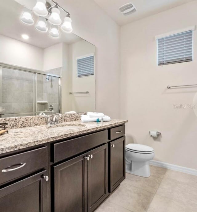 bathroom featuring a shower with door, tile patterned floors, toilet, a chandelier, and vanity