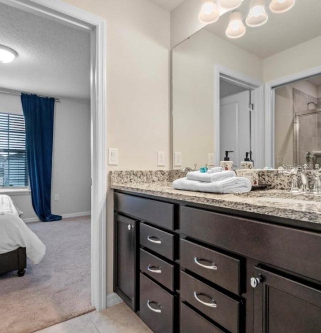 bathroom featuring vanity, a textured ceiling, and walk in shower