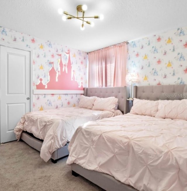 carpeted bedroom featuring a textured ceiling