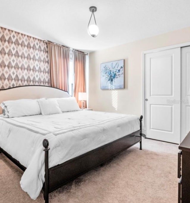 bedroom with light colored carpet