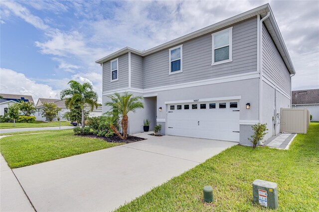 14007 Creek Harbor Dr, Orlando, FL 32824 - view of front of house featuring stucco siding, a front lawn, concrete driveway, and an attached garage