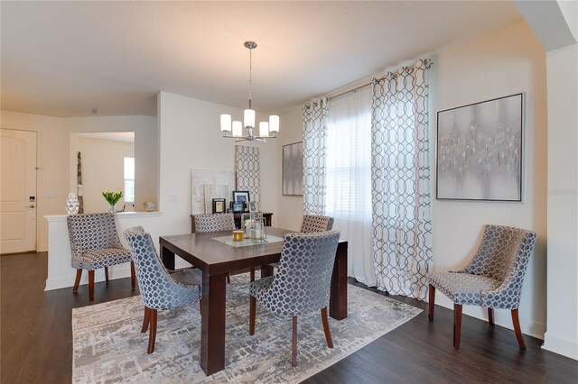 14007 Creek Harbor Dr, Orlando, FL 32824 - dining room with a notable chandelier, baseboards, and wood finished floors