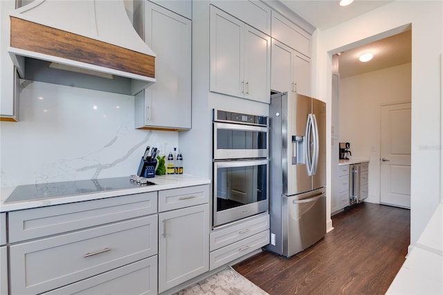 14007 Creek Harbor Dr, Orlando, FL 32824 - kitchen featuring dark wood-style floors, gray cabinets, custom range hood, appliances with stainless steel finishes, and tasteful backsplash