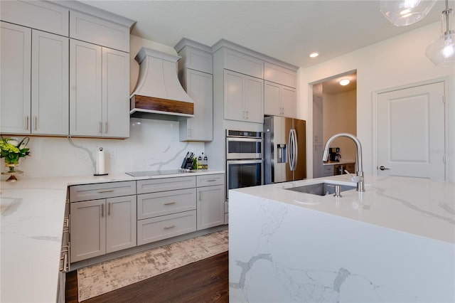 14007 Creek Harbor Dr, Orlando, FL 32824 - kitchen featuring gray cabinetry, premium range hood, dark wood finished floors, stainless steel appliances, and a sink