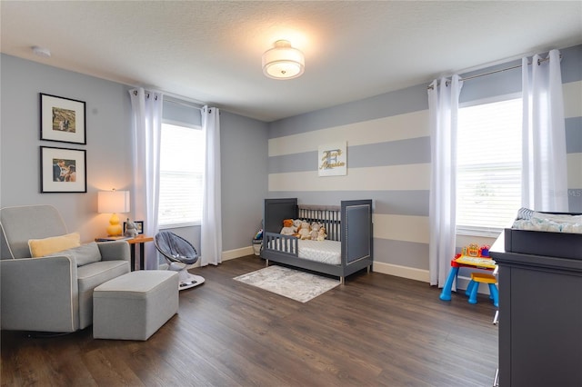 14007 Creek Harbor Dr, Orlando, FL 32824 - bedroom with a crib, multiple windows, wood finished floors, and baseboards