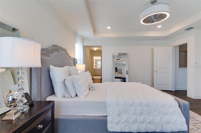 14007 Creek Harbor Dr, Orlando, FL 32824 - bedroom with visible vents, dark wood-type flooring, recessed lighting, ensuite bathroom, and a raised ceiling
