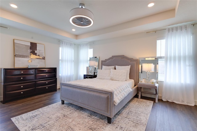 14007 Creek Harbor Dr, Orlando, FL 32824 - bedroom with multiple windows, a raised ceiling, and wood finished floors