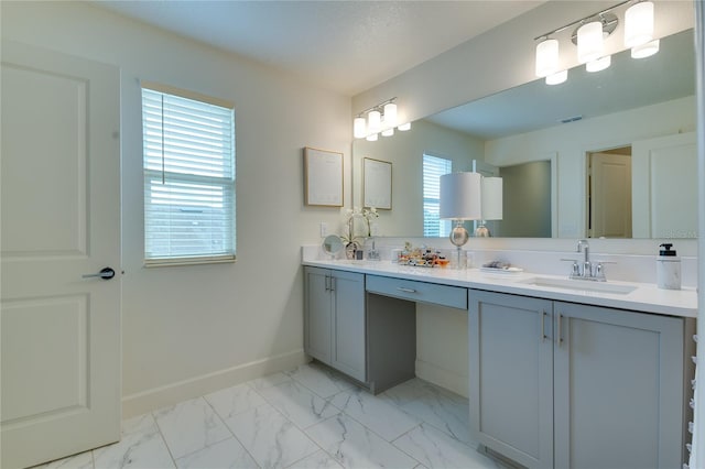 14007 Creek Harbor Dr, Orlando, FL 32824 - bathroom featuring visible vents, baseboards, double vanity, marble finish floor, and a sink