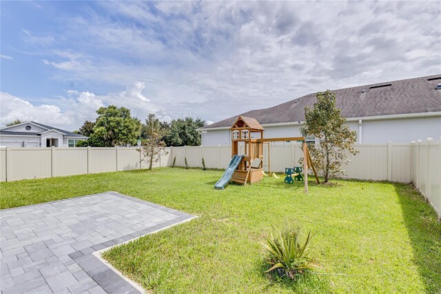 14007 Creek Harbor Dr, Orlando, FL 32824 - view of yard featuring a patio, a playground, and a fenced backyard