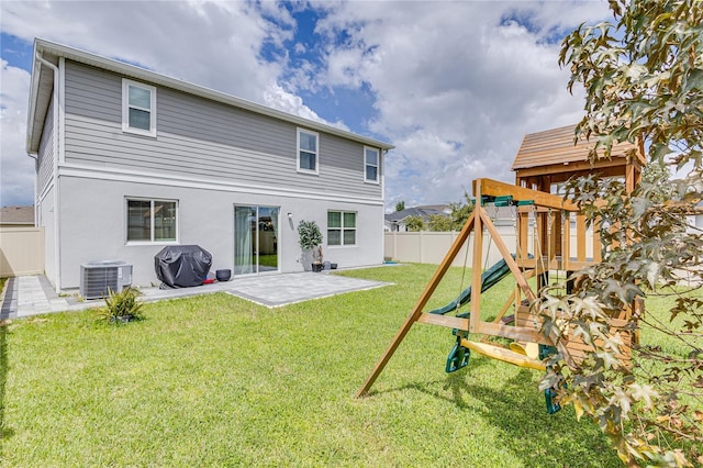 14007 Creek Harbor Dr, Orlando, FL 32824 - back of house with a playground, fence, central air condition unit, a yard, and a patio area