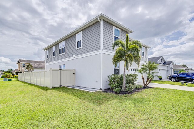14007 Creek Harbor Dr, Orlando, FL 32824 - view of side of home with a garage, a lawn, concrete driveway, and fence