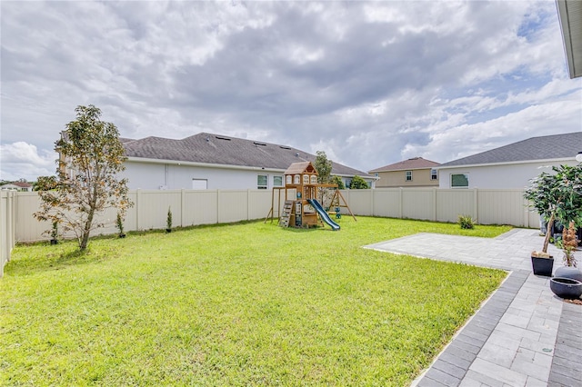 14007 Creek Harbor Dr, Orlando, FL 32824 - view of yard featuring a playground, a fenced backyard, and a patio area