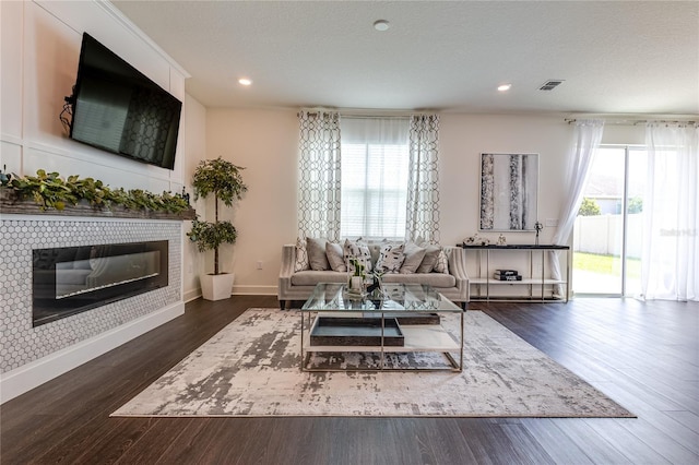 14007 Creek Harbor Dr, Orlando, FL 32824 - living area featuring a glass covered fireplace, recessed lighting, dark wood-type flooring, and baseboards