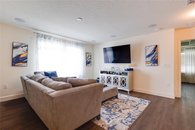 14007 Creek Harbor Dr, Orlando, FL 32824 - living room featuring visible vents, baseboards, a textured ceiling, and dark wood-style flooring