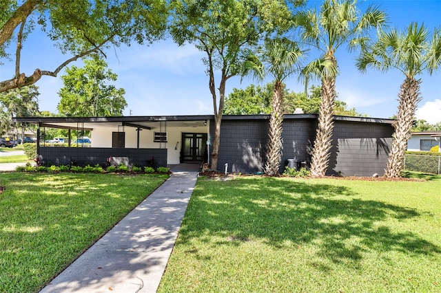 single story home with a carport and a front lawn