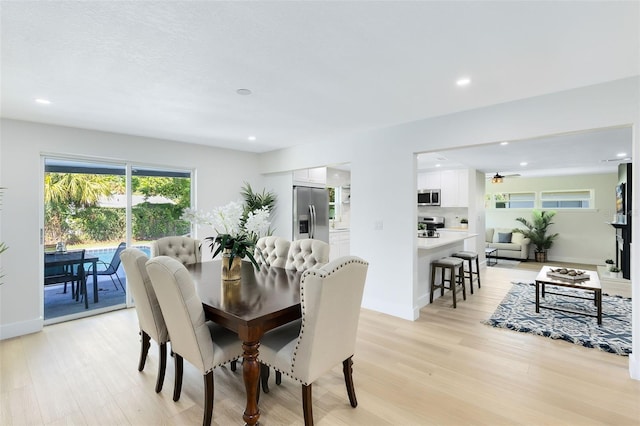 dining space with light hardwood / wood-style flooring