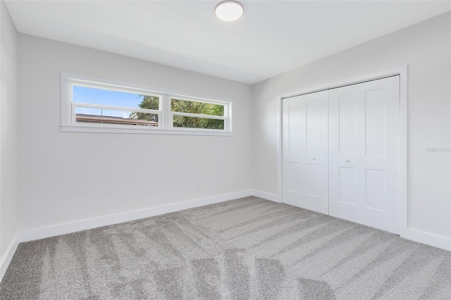 unfurnished bedroom with a closet and carpet flooring