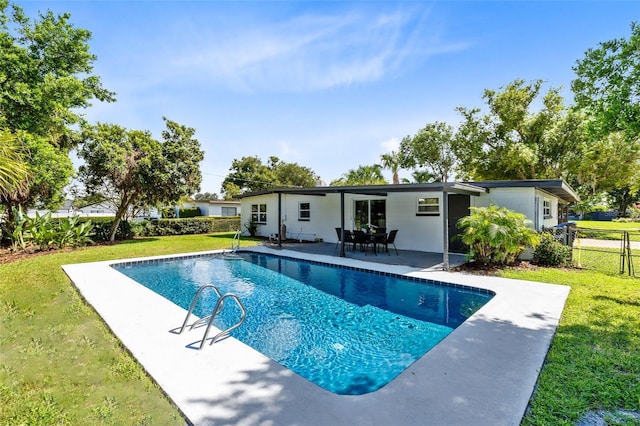 view of pool featuring a yard and a patio area