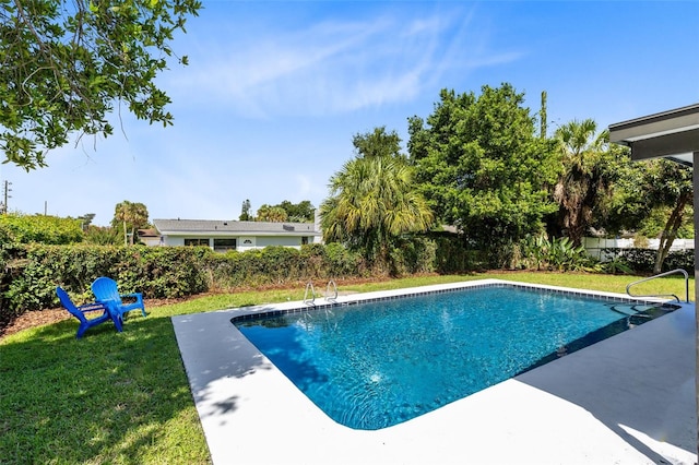 view of swimming pool featuring a yard and a patio area