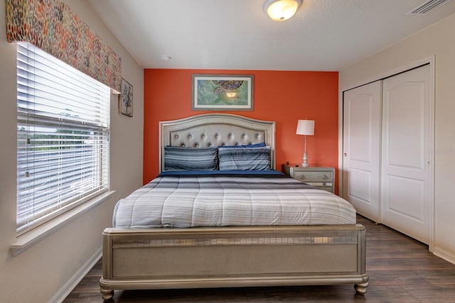 bedroom featuring a closet and dark wood-type flooring